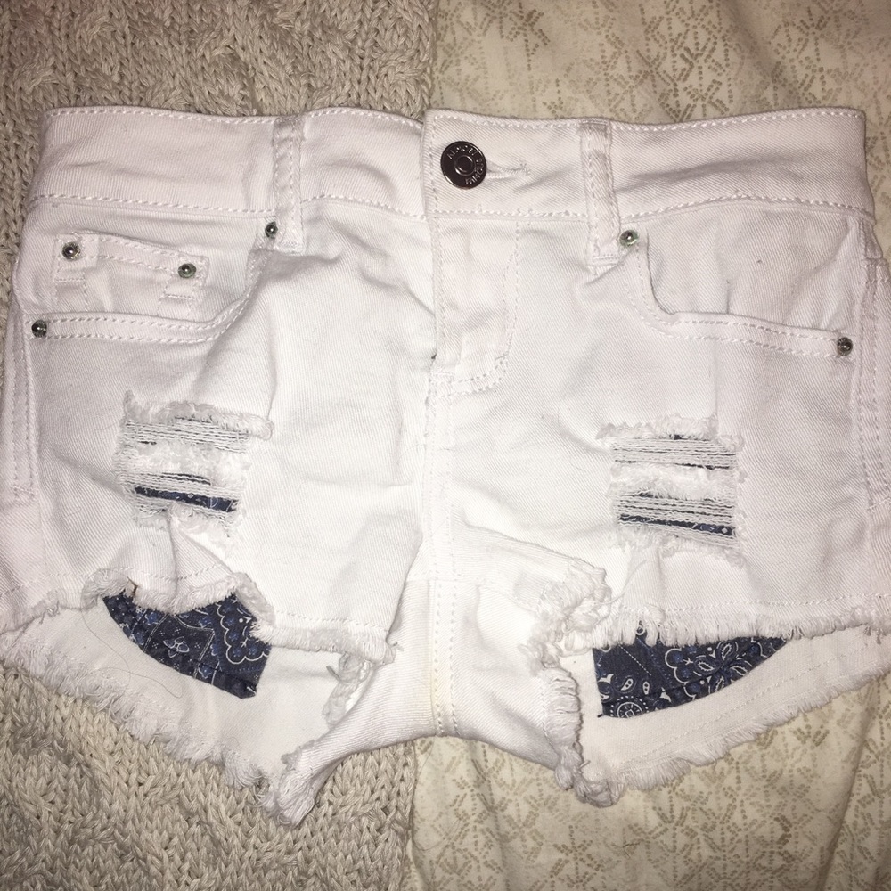 Cut off white jean shorts with patterned pockets